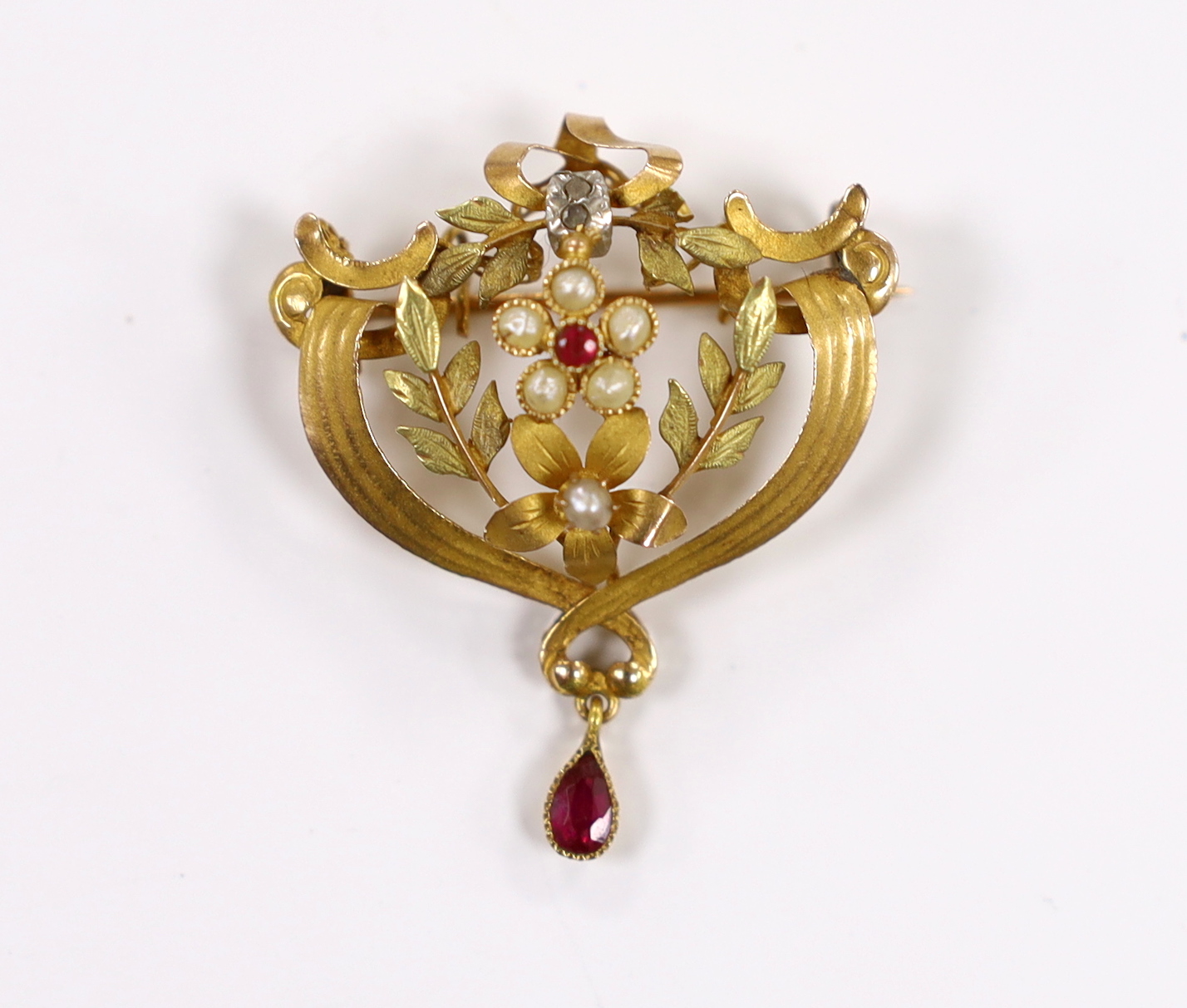 An early 20th century French two colour yellow metal (18ct poincon mark), rose cut diamond, ruby and split pearl set drop pendant brooch, 36mm, gross weight 4 grams.